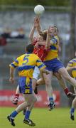 3 July 2004; Conor McCarthy and  Dermot Hurley, hidden, Cork, outjump Clare's Ger Quinlan. Bank of Ireland Football Championship Qualifier, Round 2, Clare v Cork, Cusack Park, Ennis, Co. Clare. Picture credit; Ray McManus / SPORTSFILE