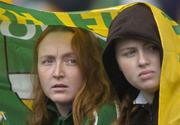 4 July 2004; Offaly supporters Olive, left, and Saoire Dunne shelter from the rain during the final moments of the game. Guinness Leinster Senior Hurling Championship Final, Offaly v Wexford, Croke Park, Dublin. Picture credit; Pat Murphy / SPORTSFILE