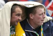 4 July 2004; Offaly supporters shelter from the rain during the game. Guinness Leinster Senior Hurling Championship Final, Offaly v Wexford, Croke Park, Dublin. Picture credit; Pat Murphy / SPORTSFILE