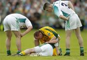 3 July 2004; Shane McKeigue, Meath, lies injured as he is attended to by team-mate Ollie Murphy and Fermanagh's Hugh Brady, left, and Barry Owens. Bank of Ireland Football Championship Qualifier, Round 2, Fermanagh v Meath, Brewster Park, Enniskillen, Co. Fermanagh. Picture credit; Brendan Moran / SPORTSFILE