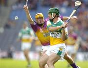 4 July 2004; Barry Teehan, Offaly, clears under pressure from Wexford's Eoin Quigley. Guinness Leinster Senior Hurling Championship Final, Offaly v Wexford, Croke Park, Dublin. Picture credit; Pat Murphy / SPORTSFILE