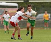 1 September 2013; Amy Kerrigan, Offaly, in action against Dania Donnelly, Derry. All-Ireland Ladies Football Junior Championship, Semi-Final, Offaly v Derry, Carrickmacross Emmets GAA Club, Emmet Park, Monaghan. Picture credit: Oliver McVeigh / SPORTSFILE