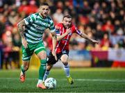 15 September 2023; Lee Grace of Shamrock Rovers in action against Paul McMullan of Derry City during the SSE Airtricity Men's Premier Division match between Derry City and Shamrock Rovers at The Ryan McBride Brandywell Stadium in Derry. Photo by Stephen McCarthy/Sportsfile
