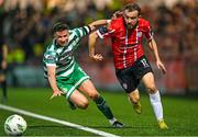 15 September 2023; Paul McMullan of Derry City in action against Ronan Finn of Shamrock Rovers during the SSE Airtricity Men's Premier Division match between Derry City and Shamrock Rovers at The Ryan McBride Brandywell Stadium in Derry. Photo by Stephen McCarthy/Sportsfile