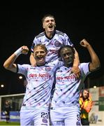 15 September 2023; Jonathan Afolabi of Bohemians, right, celebrates with team-mates Kris Twardek, left, and James McManus, top, after scoring their side's third goal, a penalty, during the Sports Direct Men’s FAI Cup quarter-final match between Drogheda United and Bohemians at Weavers Park in Drogheda, Louth. Photo by Seb Daly/Sportsfile
