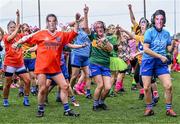 16 September 2023; Players from the Galbally team from Tyrone, wearing masks of well-known GAA personalities, during the 2023 LGFA/Sports Direct Gaelic4Mothers&Others National Blitz Day at Naomh Mearnóg GAA club in Portmarnock, Dublin. Photo by Piaras Ó Mídheach/Sportsfile