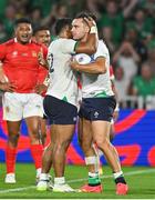 16 September 2023; James Lowe of Ireland celebrates with teammate Bundee Aki after scoring his side's fifth try during the 2023 Rugby World Cup Pool B match between Ireland and Tonga at Stade de la Beaujoire in Nantes, France. Photo by Brendan Moran/Sportsfile
