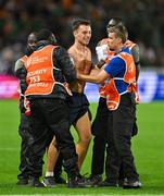 16 September 2023; A pitch invader is detained by security during the 2023 Rugby World Cup Pool B match between Ireland and Tonga at Stade de la Beaujoire in Nantes, France. Photo by Brendan Moran/Sportsfile