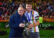 18 September 2023; Cian Byrne of Bohemians is presented with the cup by former Leinster Football Association President Tony Martin after his side's victory in the Leinster Football Senior Cup Final match between Usher Celtic and Bohemians at Dalymount Park in Dublin. Photo by Sam Barnes/Sportsfile