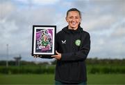 19 September 2023; Ireland Women’s National Team player Katie McCabe with their commemorative collage by SSE Airtricity at the FAI National Training Centre in Abbotstown, Dublin. Photo by Stephen McCarthy/Sportsfile