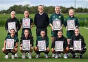19 September 2023; FAI chief executive officer Jonathan Hill with Ireland Women’s National Team players, back row, from left, Denise O'Sullivan, Chloe Mustaki, Louise Quinn and Amber Barrett, with, front row, Jamie Finn, Heather Payne, Abbie Larkin, Katie McCabe and Claire O'Riordan with their commemorative collages by SSE Airtricity at the FAI National Training Centre in Abbotstown, Dublin. Photo by Stephen McCarthy/Sportsfile
