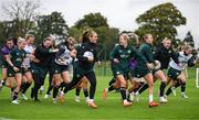 19 September 2023; Players, including Grace Moloney, left, and Lily Agg go around interim assistant coach Emma Byrne as part of a warm-up drill during a Republic of Ireland women training session at the FAI National Training Centre in Abbotstown, Dublin. Photo by Stephen McCarthy/Sportsfile
