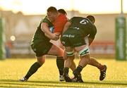 22 September 2023; John Ryan of Munster is tackled by Peter Dooley, left, and Shamus Hurley-Langton of Connacht during the pre season friendly match between Connacht and Munster at The Sportsground in Galway. Photo by Ben McShane/Sportsfile