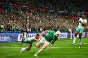23 September 2023; Mack Hansen of Ireland evades the tackle of Manie Libbok of South Africa on his way to scoring his side's first try during the 2023 Rugby World Cup Pool B match between South Africa and Ireland at Stade de France in Paris, France. Photo by Harry Murphy/Sportsfile