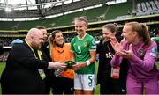 23 September 2023; Republic of Ireland's Caitlin Hayes is presented with her first cap by media officer Gareth Maher after the UEFA Women's Nations League B1 match between Republic of Ireland and Northern Ireland at Aviva Stadium in Dublin. Photo by Stephen McCarthy/Sportsfile