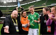 23 September 2023; Republic of Ireland's Caitlin Hayes is presented with her first cap by media officer Gareth Maher after the UEFA Women's Nations League B1 match between Republic of Ireland and Northern Ireland at Aviva Stadium in Dublin. Photo by Stephen McCarthy/Sportsfile