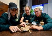 25 September 2023; Republic of Ireland players, from left, Denise O'Sullivan, Megan Connolly and Savannah McCarthy with a bearded dragon at Zoo Café in Budapest, Hungary, during some down time ahead of their UEFA Women's Nations League B1 match against Hungary, on Tuesday. Photo by Stephen McCarthy/Sportsfile