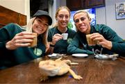 25 September 2023; Republic of Ireland players, from left, Denise O'Sullivan, Megan Connolly and Savannah McCarthy with a bearded dragon at Zoo Café in Budapest, Hungary, during some down time ahead of their UEFA Women's Nations League B1 match against Hungary, on Tuesday. Photo by Stephen McCarthy/Sportsfile