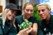 25 September 2023; Republic of Ireland players, from left, Denise O'Sullivan, Megan Connolly and Savannah McCarthy with Flash, a chameleon, at Zoo Café in Budapest, Hungary, during some down time ahead of their UEFA Women's Nations League B1 match against Hungary, on Tuesday. Photo by Stephen McCarthy/Sportsfile