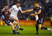 25 September 2023; Jack Moylan of Shelbourne is tackled by James McManus of Bohemians, left, and Kacper Radkowski during the SSE Airtricity Men's Premier Division match between Bohemians and Shelbourne at Dalymount Park in Dublin. Photo by Tyler Miller/Sportsfile