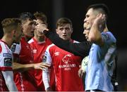 25 September 2023; St Patrick's Athletic players remonstrate with referee David Dunne after he showed a red card to Sam Curtis during the SSE Airtricity Men's Premier Division match between St Patrick's Athletic and Drogheda United at Richmond Park in Dublin. Photo by David Fitzgerald/Sportsfile