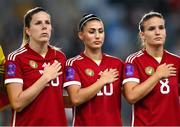 26 September 2023; Hungary players, from left, Lilla Turányi, Dora Sule and Viktória Szabó stand for the playing of the National Anthem before the UEFA Women's Nations League B1 match between Hungary and Republic of Ireland at Hidegkuti Nándor Stadium in Budapest, Hungary. Photo by Stephen McCarthy/Sportsfile
