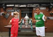 28 September 2023; Cliftonville FC player Ollie Thompson, age 7, left, and St Patrick's FC player Leroy Agunbiade, age 11, as descendants of Alton United receive the Sports Direct Men’s FAI Cup for the first time in Carrick Hill, Belfast on the 100th anniversary of the Club winning the Cup as the only Belfast team to win the competition in its history. Photo by David Fitzgerald/Sportsfile