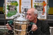 28 September 2023; Sean Brennan from Carrick Hill, whose grandfather Michael Brennan played in the 1923 final, poses with the cup as descendants of Alton United receive the Sports Direct Men’s FAI Cup for the first time in Carrick Hill, Belfast on the 100th anniversary of the Club winning the Cup as the only Belfast team to win the competition in its history. Photo by David Fitzgerald/Sportsfile