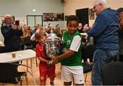 28 September 2023; Cliftonville FC player Ollie Thompson, age 7, left, and St Patrick's FC player Leroy Agunbiade, age 11, as descendants of Alton United receive the Sports Direct Men’s FAI Cup for the first time in Carrick Hill, Belfast on the 100th anniversary of the Club winning the Cup as the only Belfast team to win the competition in its history. Photo by David Fitzgerald/Sportsfile