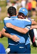 29 September 2023; Shane Lowry of Europe, right, congratulates teammate Rory McIlroy on the 17th green after his pairing's victory during the morning foursomes matches on day one of the 2023 Ryder Cup at Marco Simone Golf and Country Club in Rome, Italy. Photo by Brendan Moran/Sportsfile