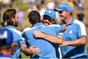 29 September 2023; Shane Lowry of Europe, right, congratulates teammate Rory McIlroy on the 17th green after his pairing's victory during the morning foursomes matches on day one of the 2023 Ryder Cup at Marco Simone Golf and Country Club in Rome, Italy. Photo by Brendan Moran/Sportsfile