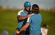29 September 2023; Jon Rahm of Europe, left, is congratulated by teammate Tommy Fleetwood on the 18th green after putting to win the hole and tie his match during the afternoon fourball matches on day one of the 2023 Ryder Cup at Marco Simone Golf and Country Club in Rome, Italy. Photo by Brendan Moran/Sportsfile