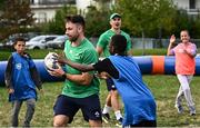 29 September 2023; Hugo Keenan and James Lowe with children during an Ireland rugby visit to Drop Quartier Rugby ran by UST Tour Rugby in Tours, France. Photo by Harry Murphy/Sportsfile