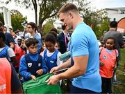 29 September 2023; Josh van der Flier hands out flags during an Ireland rugby visit to Drop Quartier Rugby ran by UST Tour Rugby in Tours, France. Photo by Harry Murphy/Sportsfile