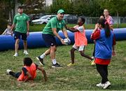 29 September 2023; James Lowe and Hugo Keenan with children during an Ireland rugby visit to Drop Quartier Rugby ran by UST Tour Rugby in Tours, France. Photo by Harry Murphy/Sportsfile