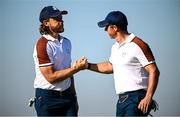 30 September 2023; Tommy Fleetwood of Europe, left, celebrates with partner Rory McIlroy after making eagle on the 11th hole during the morning foursomes on day two of the 2023 Ryder Cup at Marco Simone Golf and Country Club in Rome, Italy. Photo by Ramsey Cardy/Sportsfile