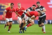 30 September 2023; Jack O'Donoghue of Munster is tackled by Aaron Shingler of Barbarians during the representative match between Munster and Barbarians at Thomond Park in Limerick. Photo by David Fitzgerald/Sportsfile