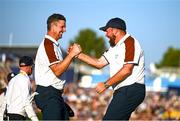 30 September 2023; Justin Rose of Europe celebrates with team-mate Shane Lowry after winning his match on the 16th hole during the afternoon fourball matches on day two of the 2023 Ryder Cup at Marco Simone Golf and Country Club in Rome, Italy. Photo by Brendan Moran/Sportsfile