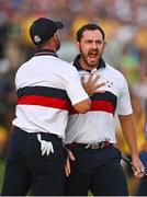 30 September 2023; Patrick Cantlay of USA celebrates with partner, Wyndham Clark, left, on the 18th green after the afternoon fourball matches on day two of the 2023 Ryder Cup at Marco Simone Golf and Country Club in Rome, Italy. Photo by Brendan Moran/Sportsfile
