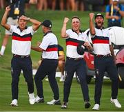 30 September 2023; Team USA players, from left, Collin Morikawa, Justin Thomas and Max Homa celebrate after team-mate Patrick Cantlay wins his match during the afternoon fourball matches on day two of the 2023 Ryder Cup at Marco Simone Golf and Country Club in Rome, Italy. Photo by Brendan Moran/Sportsfile