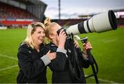 30 September 2023; Megan Gaffney, right, and Ailsa Hughes of Barbarians test out a camera after the representative match between Munster and Barbarians at Thomond Park in Limerick. Photo by David Fitzgerald/Sportsfile