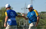 1 October 2023; Shane Lowry of Europe celebrates with caddie Darren Reynolds on the 14th hole during the singles matches on the final day of the 2023 Ryder Cup at Marco Simone Golf and Country Club in Rome, Italy. Photo by Brendan Moran/Sportsfile