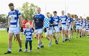 1 October 2023; Tinryland captain Shane Redmond and his daughter Saoirse, age 4, walk the parade before the Carlow County Senior Club Football Championship final match between Tinryland and Éire Óg at Netwatch Cullen Park in Carlow. Photo by Matt Browne/Sportsfile
