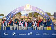 1 October 2023; Team Europe captain Luke Donald, centre, lifts the Ryder cup with his team, from left, Tommy Fleetwood, Sepp Straka, Shane Lowry, Matt Fitzpatrick, Justin Rose, Tyrrell Hatton, Nicolai Højgaard, Rory McIlroy, Viktor Hovland, Ludvig Åberg, Robert MacIntyre and Jon Rahm during the singles matches on the final day of the 2023 Ryder Cup at Marco Simone Golf and Country Club in Rome, Italy. Photo by Ramsey Cardy/Sportsfile