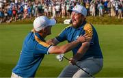 1 October 2023; Shane Lowry of Europe celebrates with team-mate Nicolai Højgaard on the 17th green during the singles matches on the final day of the 2023 Ryder Cup at Marco Simone Golf and Country Club in Rome, Italy. Photo by Brendan Moran/Sportsfile