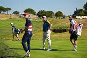 1 October 2023; Shane Lowry of Europe and Jordan Spieth of USA and their caddies Darren Reynolds, left, and Michael Greller watch from the 10th box as their teammates Jon Rahm of Europe and Scottie Scheffler of USA (not pictured) halve their match on the 18th green during the singles matches on the final day of the 2023 Ryder Cup at Marco Simone Golf and Country Club in Rome, Italy. Photo by Brendan Moran/Sportsfile