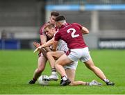 7 October 2023; Paul Mannion of Kilmacud Crokes is tackled by Ben McHugh, 2, and Alan McLoughlin of Raheny during the Dublin County Senior Club Championship Football Semi-Final match between Kilmacud Crokes and Raheny at Parnell Park in Dublin. Photo by Stephen Marken/Sportsfile