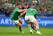 7 October 2023; Finn Russell of Scotland is tackled by Ireland players Tadhg Furlong, left, and Dan Sheehan during the 2023 Rugby World Cup Pool B match between Ireland and Scotland at the Stade de France in Paris, France. Photo by Brendan Moran/Sportsfile