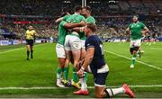 7 October 2023; Hugo Keenan of Ireland, centre, celebrates with teammates Jamison Gibson-Park, left, and Stuart McCloskey, right, after scoring their side's second try during the 2023 Rugby World Cup Pool B match between Ireland and Scotland at the Stade de France in Paris, France. Photo by Harry Murphy/Sportsfile