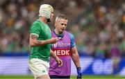 7 October 2023; Mack Hansen of Ireland leads the pitch for a second time to receive medical attention with Ireland team doctor Ciaran Cosgrave during the 2023 Rugby World Cup Pool B match between Ireland and Scotland at the Stade de France in Paris, France. Photo by Brendan Moran/Sportsfile